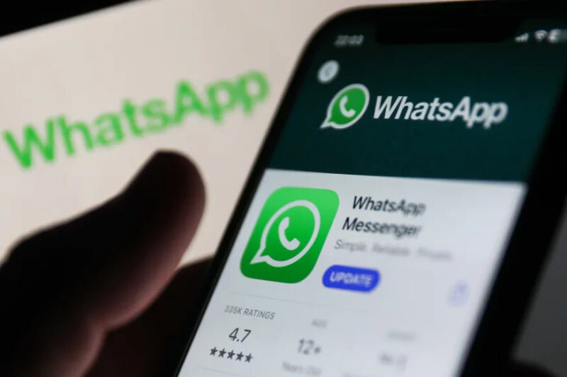 WhatsApp on App Store displayed on a phone screen and WhatsApp logo displayed on a screen in the background are seen in this illustration photo taken in Krakow, Poland on Auguust 13, 2023. (Photo by Jakub Porzycki/NurPhoto via Getty Images)