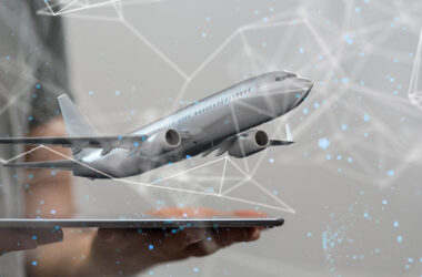 Realistic illustration of a plane tacking off from a computer tablet a person is holding. Geometric white lines and blue dots surround the scene