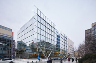 Photo of the facade of the MIT Schwarzman College of Computing building, which features a shingled glass exterior that reflects its surroundings